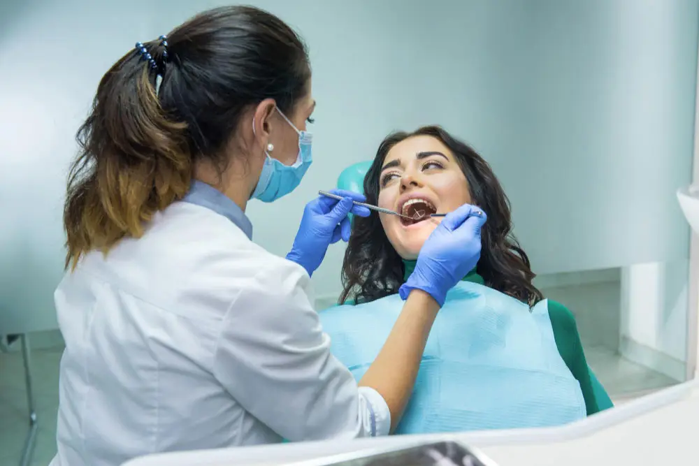 A woman getting Pain-Free dental bonding procedure at our Silver spring dental office