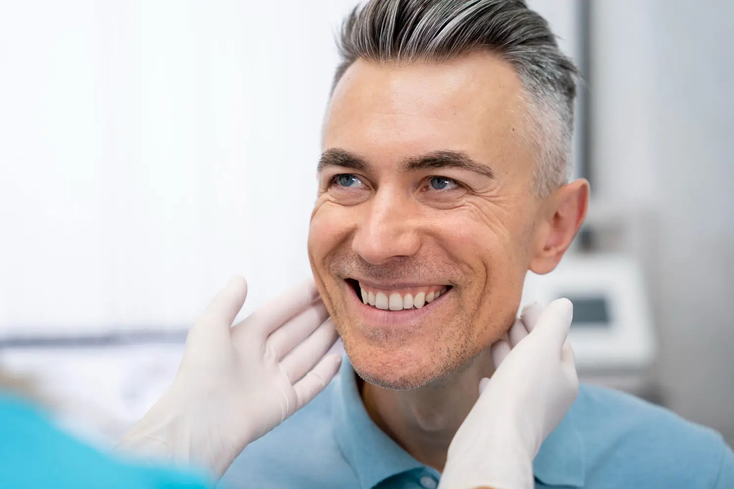 A male patient looking happy after receiving dental bridges service at our clinic