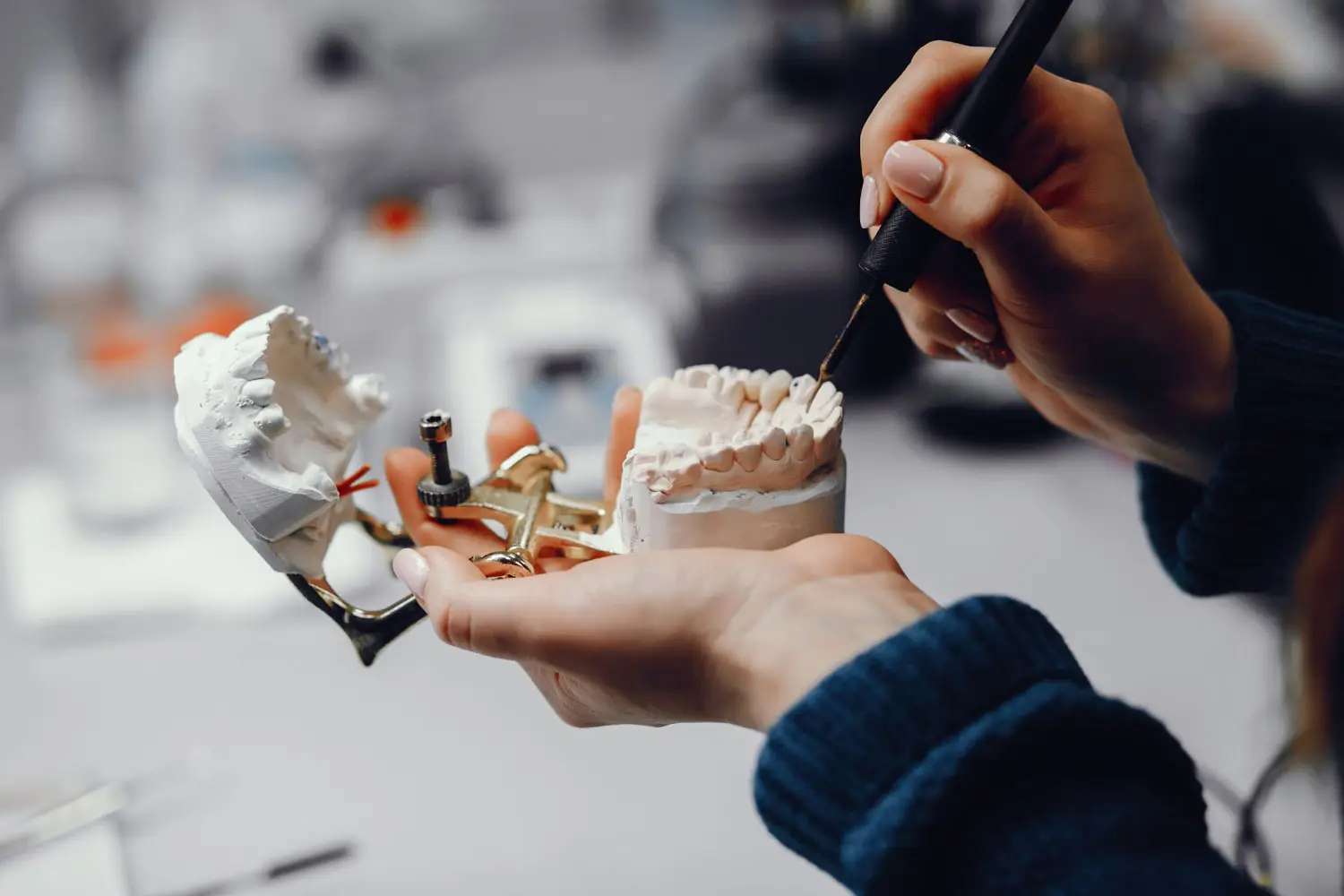 Our orthodontist working on perfecting patients' dental implants